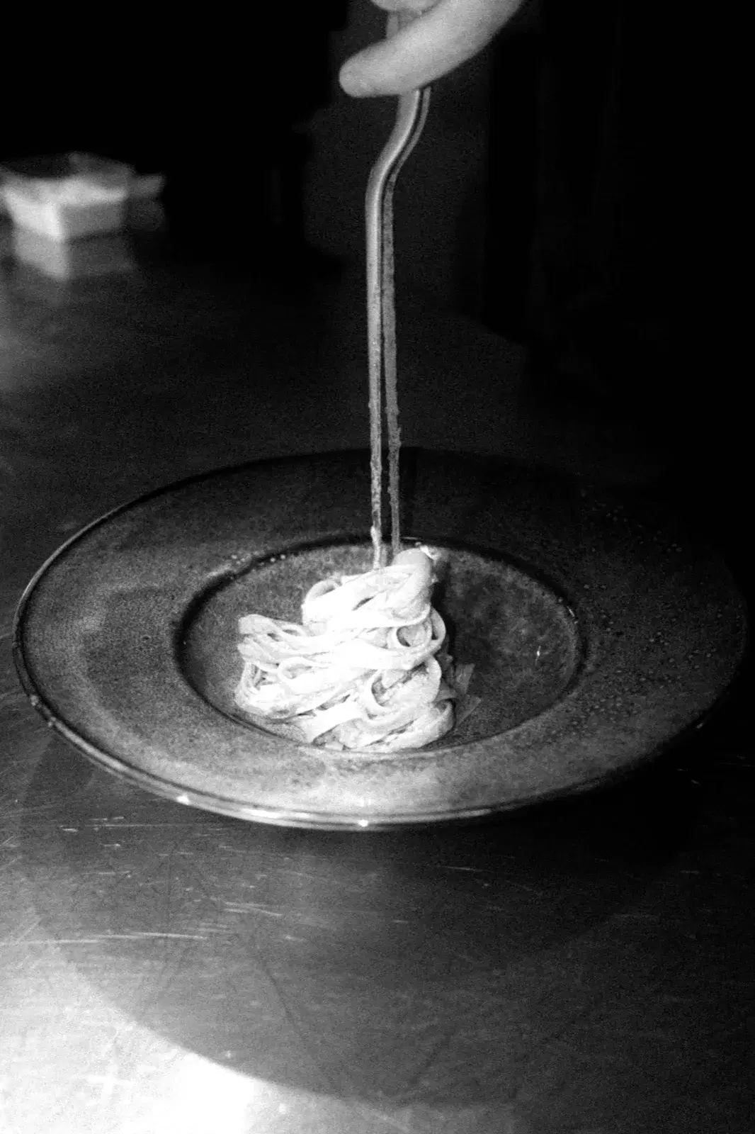 Fresh pasta lifted from a plate